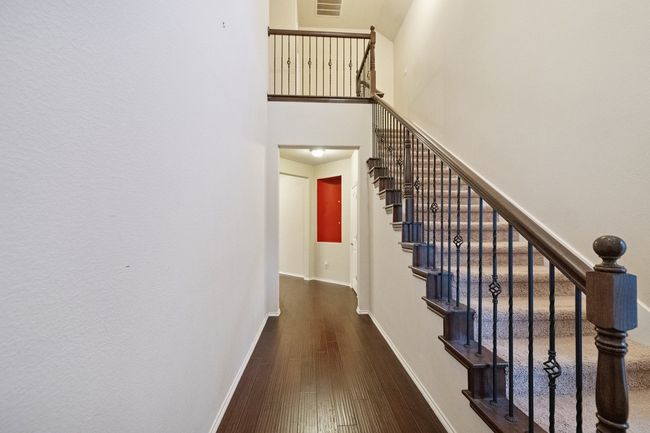 Stairway with a high ceiling and hardwood / wood-style flooring | Image 19