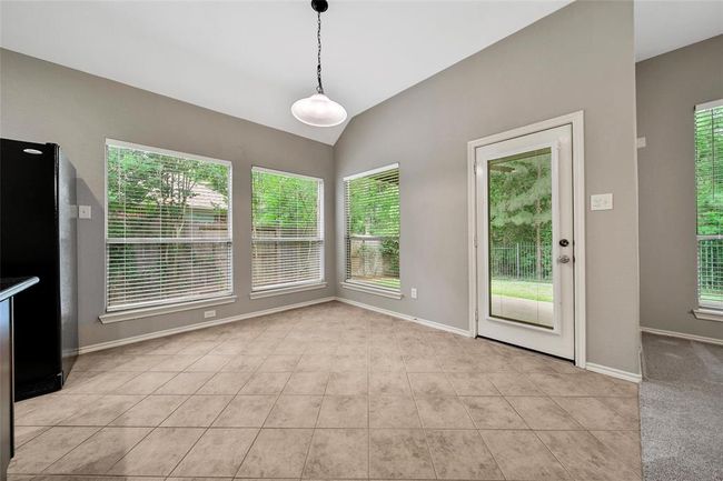The casual dining area overlooks the greenbelt reserve for tranquil views. | Image 13