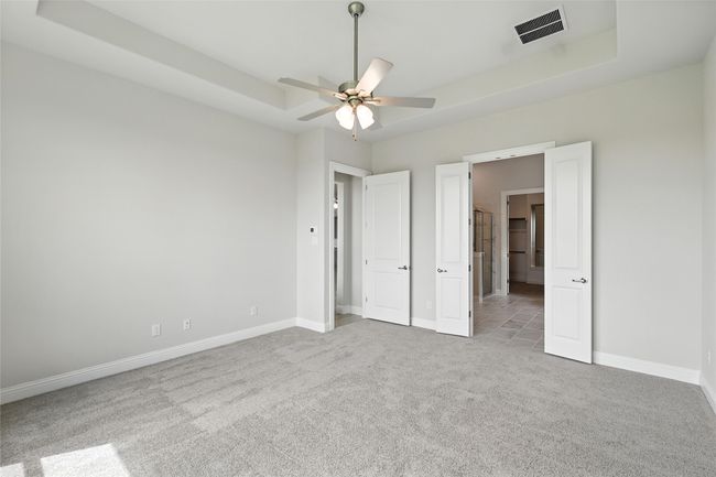 Unfurnished bedroom featuring carpet floors and a raised ceiling | Image 15
