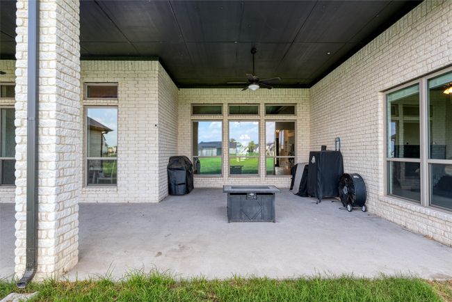 View of patio / terrace with a ceiling fan and a fire pit | Image 29