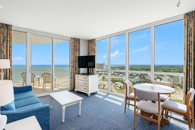 Living area featuring expansive windows and carpet floors | Image 7