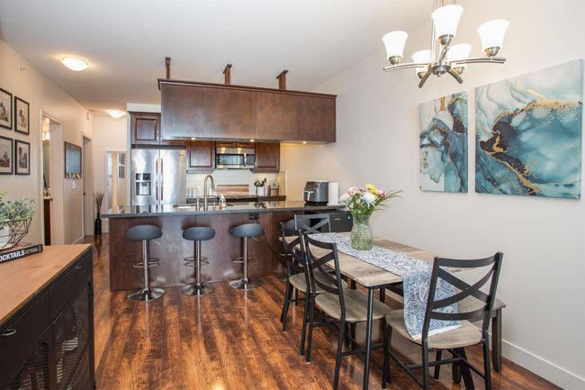 Dining room featuring a notable chandelier, dark wood-style floors, and baseboards | Image 8