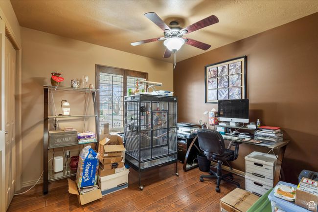 Office space featuring a ceiling fan and wood-type flooring | Image 19