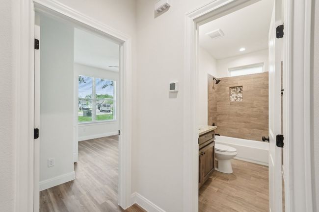 Bathroom with baseboards, toilet, vanity, and tile wood style floors | Image 26
