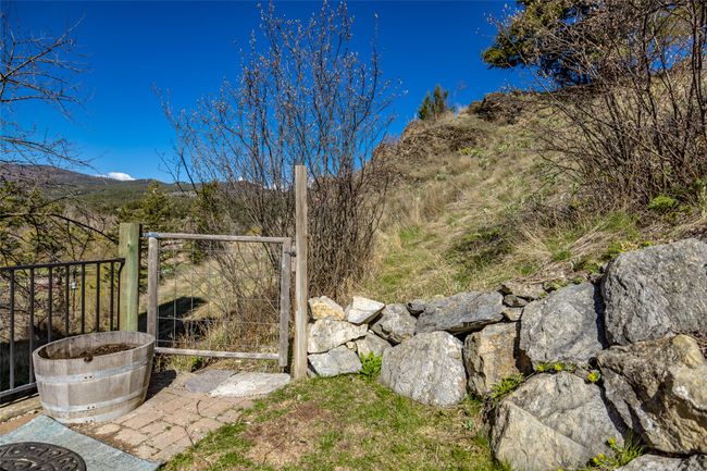 View of yard featuring a gate and a mountain view | Image 77