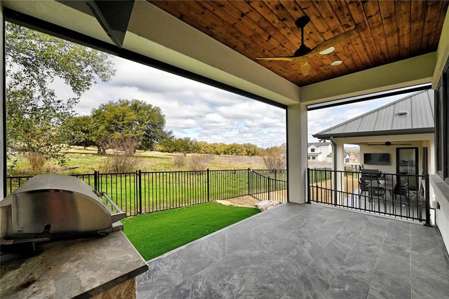 View of patio / terrace with a grill, a fenced backyard, and a ceiling fan | Image 30