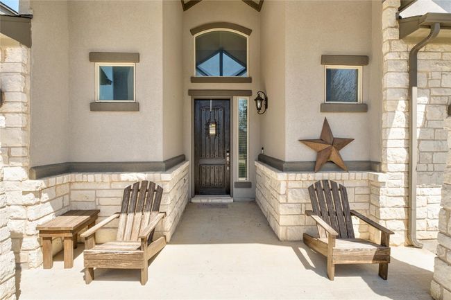 View of exterior entry with stucco siding and stone siding | Image 4