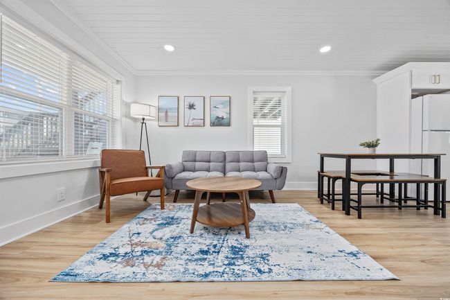 Living area with plenty of natural light, ornamental molding, baseboards, light wood-style floors, and recessed lighting | Image 5
