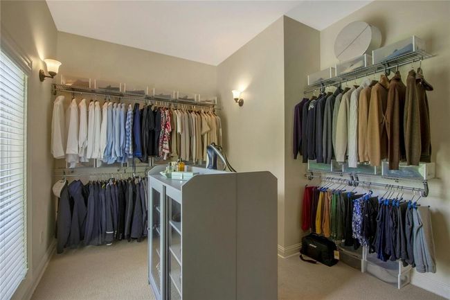 Spacious closet with light carpet | Image 21