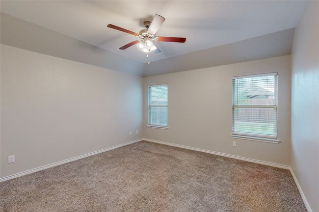 Carpeted spare room with baseboards and a ceiling fan | Image 33