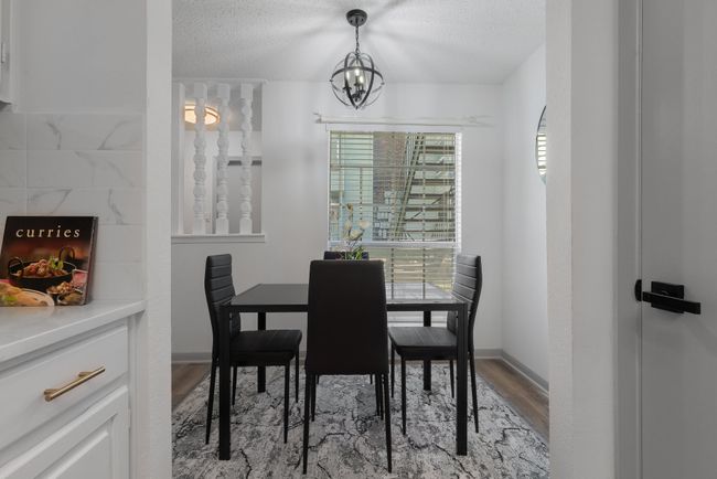 Dining area with light wood-style flooring, baseboards, an inviting chandelier, and a textured ceiling | Image 14