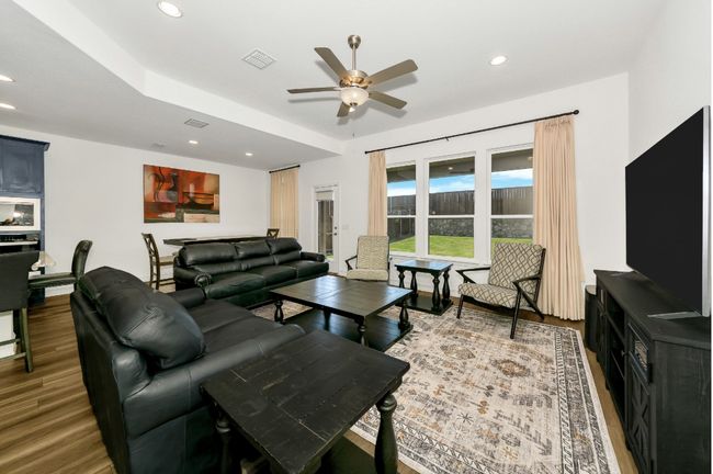 Living room featuring recessed lighting, wood finished floors, visible vents, and a ceiling fan | Image 18