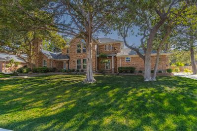 View of front of home with a front lawn and a balcony | Image 2