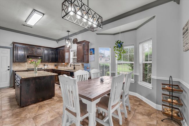 Dining space featuring crown molding, baseboards, and light tile patterned floors | Image 5