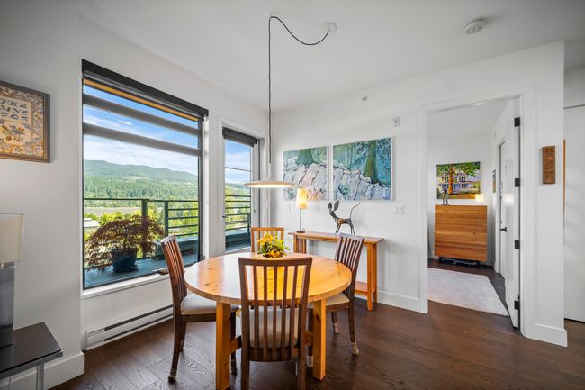 Dining room featuring baseboard heating, dark wood-style floors, and a mountain view | Image 8