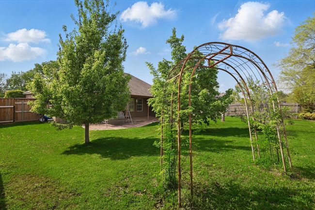 View of yard featuring a patio area and fence | Image 34