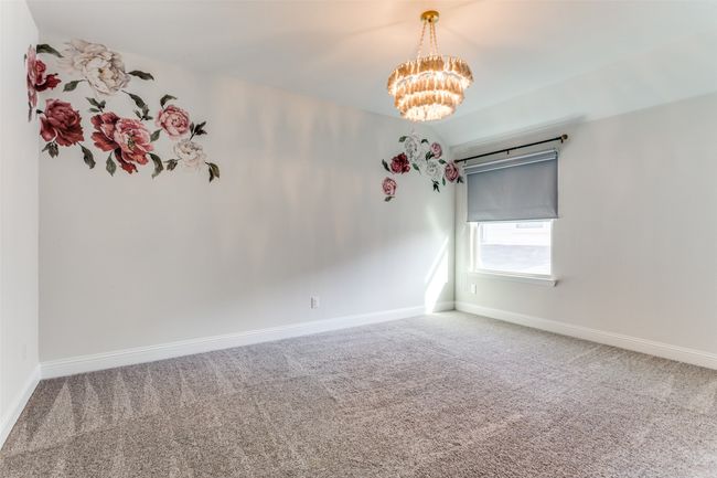Empty room featuring carpet floors and an inviting chandelier | Image 22