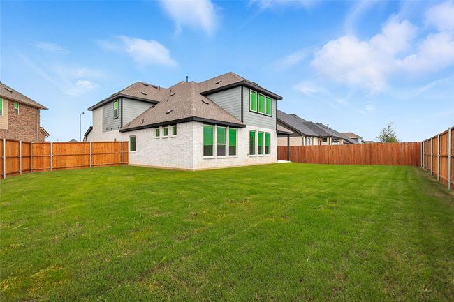 Back of property with brick siding, a shingled roof, and a fenced backyard | Image 30