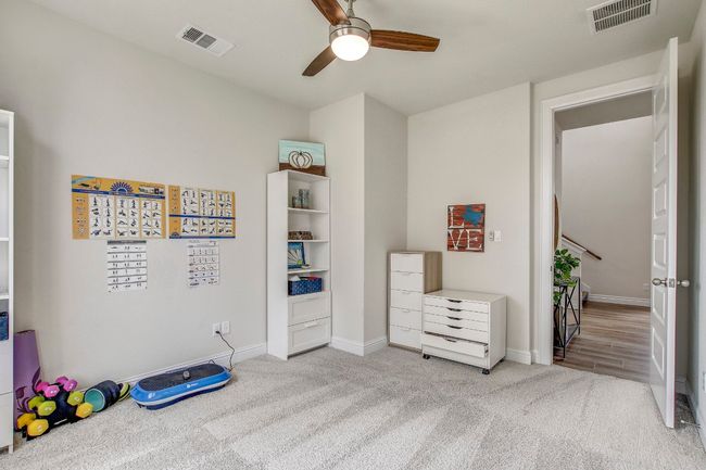 Bedroom with carpet flooring and a ceiling fan | Image 22