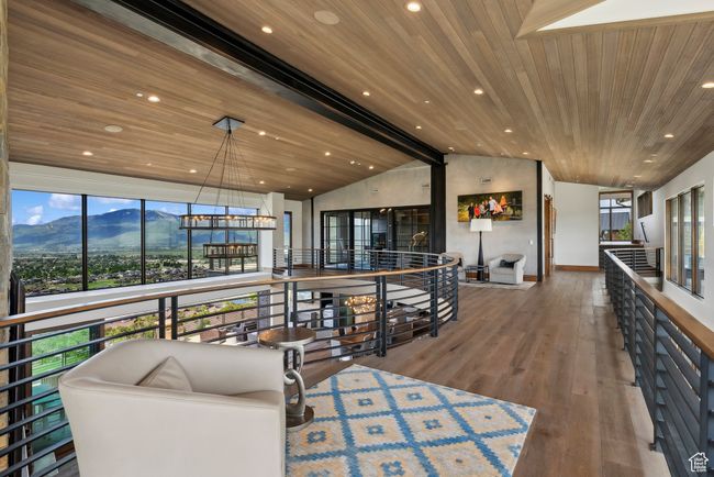 Living room with a mountain view, wood ceiling, vaulted ceiling, wood finished floors, and recessed lighting | Image 99