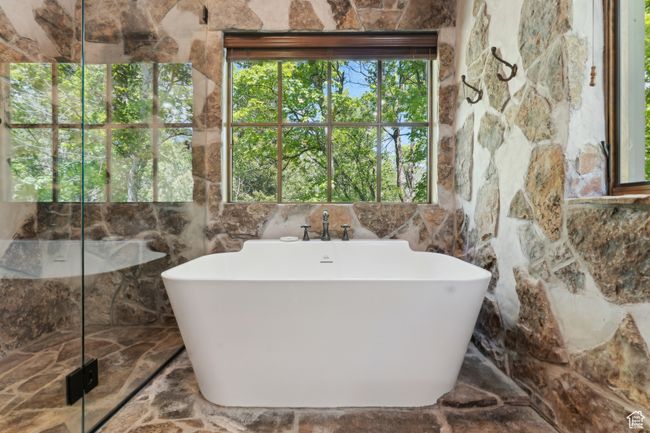 Full bath featuring a soaking tub and a marble finish shower | Image 21