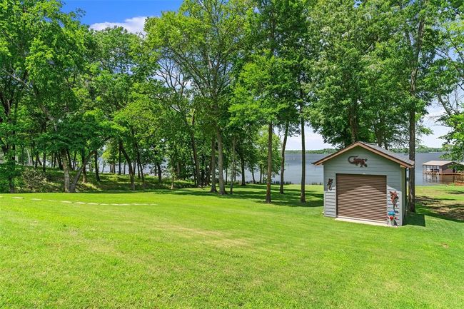 View of yard featuring a garage and an outdoor structure | Image 29