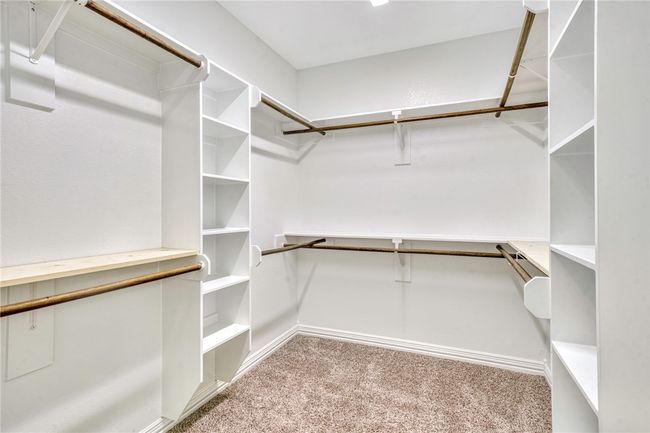 Walk in closet with carpet floors | Image 17