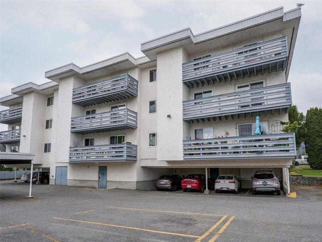 View of apartment building / complex with covered parking | Image 22