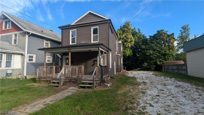 View of front of home featuring a front yard and a porch | Image 1