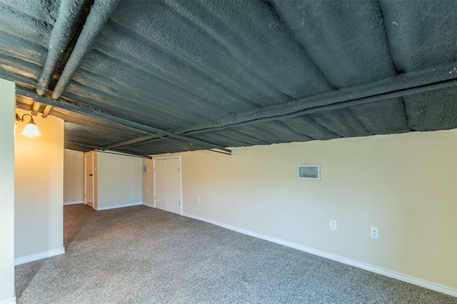 Carpeted empty room with visible vents and baseboards | Image 24