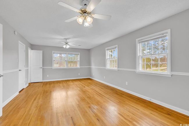 Spare room featuring a ceiling fan and light wood finished floors | Image 17