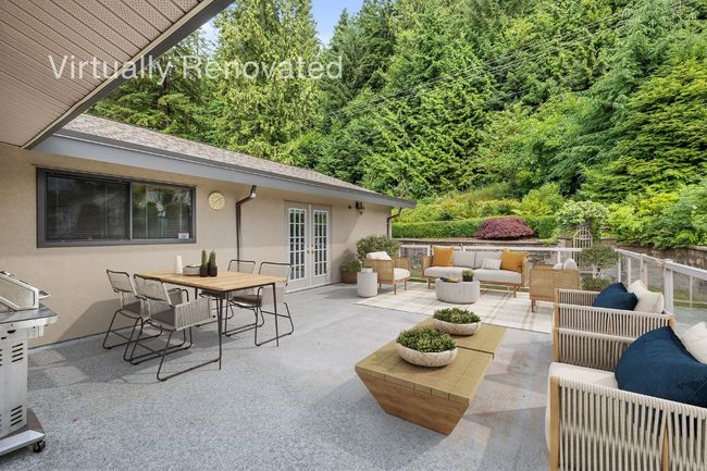 View of patio featuring area for grilling, fence, outdoor dining area, an outdoor hangout area, and french doors | Image 24