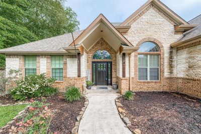 Inviting covered entryway with elegant arches and a welcoming atmosphere. | Image 3