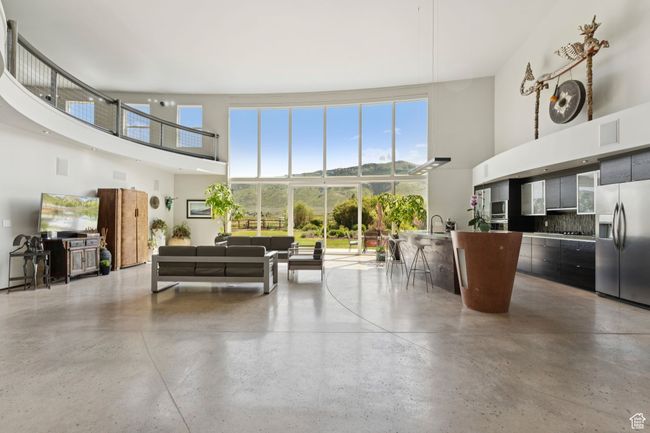 Common area featuring a towering ceiling and a sink | Image 6