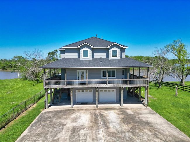 View of the home and river as you enter the property | Image 6