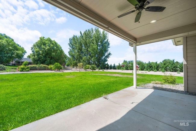 View of yard with a ceiling fan and a patio area | Image 34