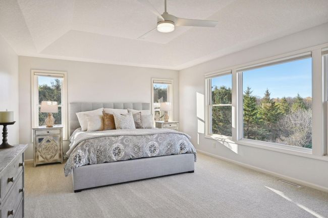 Tray ceiling enhances the expansiveness of the main bedroom. | Image 36
