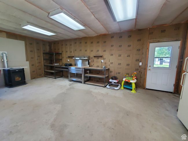 Garage with a wood stove and freestanding refrigerator | Image 18