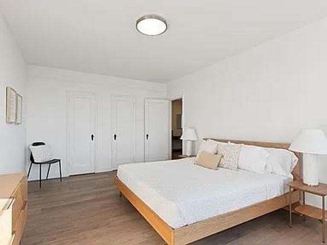 Bedroom with light wood finished floors | Image 6