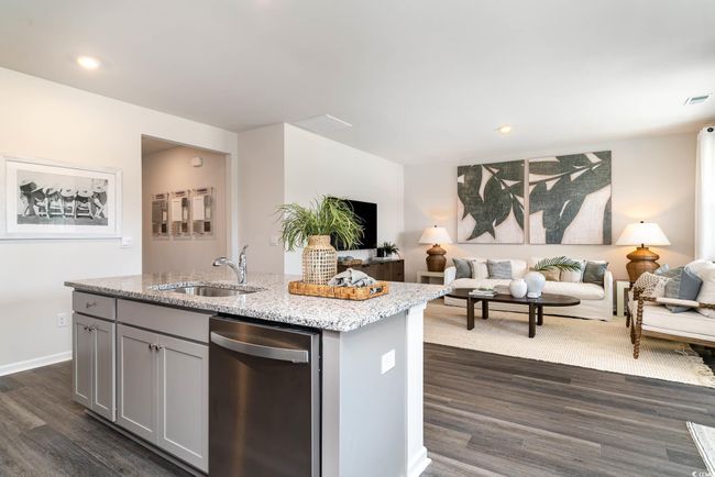 Kitchen with a sink, open floor plan, dishwasher, gray cabinets, and dark wood finished floors | Image 5