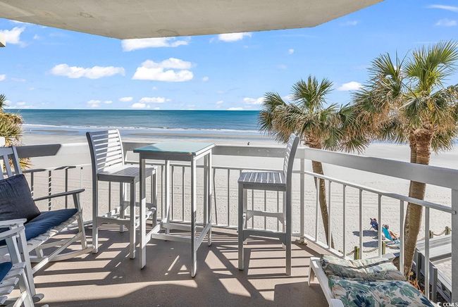 Balcony featuring a water view and a view of the beach | Image 26