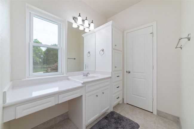 Primary bathroom with double closets, double sinks, and an oversized shower. | Image 24
