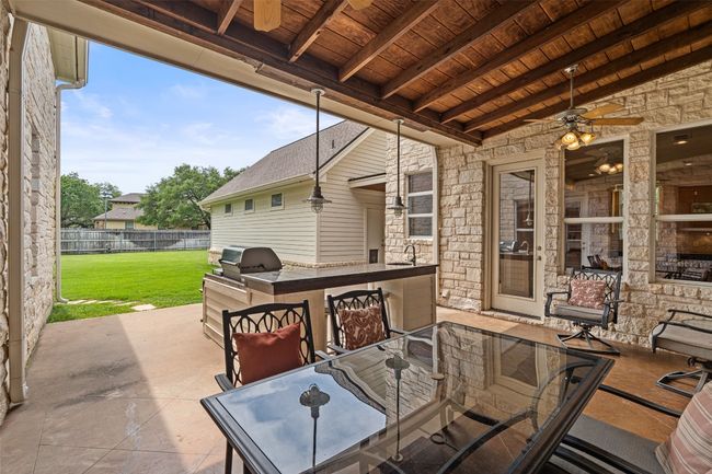 View of patio / terrace with ceiling fan, outdoor dining space, and a sink | Image 32