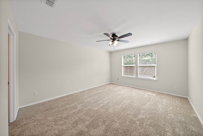 Spare room featuring ceiling fan and carpet flooring | Image 21