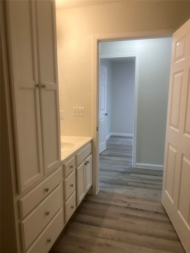 Bathroom with wood finished floors and vanity | Image 11