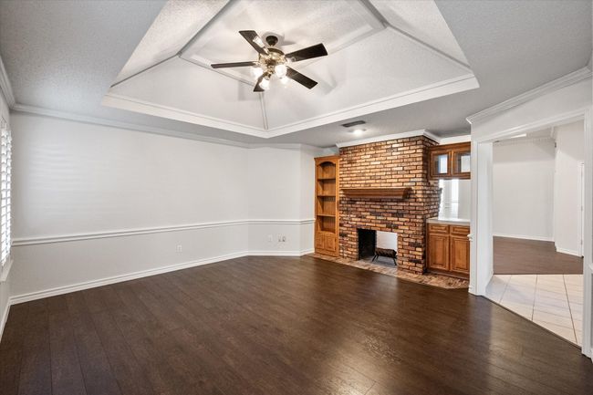 The creamy white paint with white trim really make the room light and bright. Without furniture, you can see how large this living room is. | Image 5