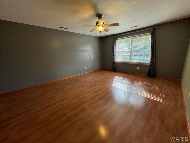 primary bedroom with laminate flooring and ceiling fan | Image 19