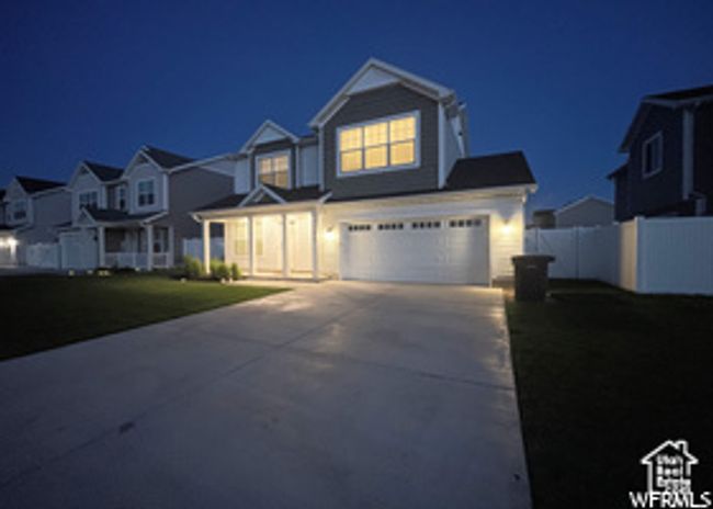 View of front of home featuring concrete driveway, a garage, and a residential view | Image 23
