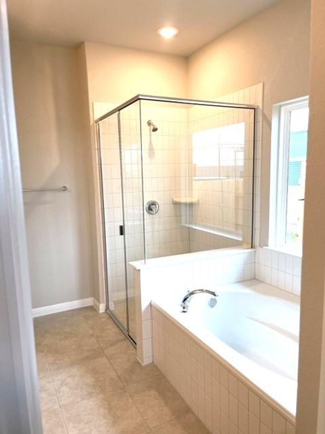 Bathroom with a shower stall, a bath, and tile patterned flooring | Image 9