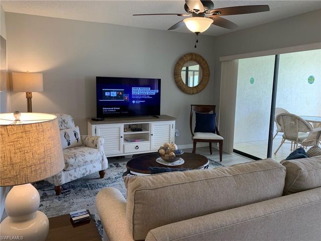 Living area featuring a ceiling fan and baseboards | Image 6